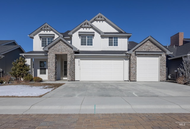 view of front of property with stone siding, board and batten siding, and concrete driveway