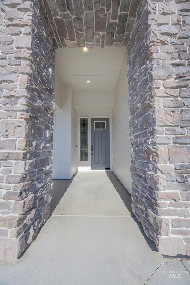 property entrance featuring stone siding