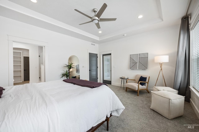 carpeted bedroom with recessed lighting, a tray ceiling, baseboards, and visible vents