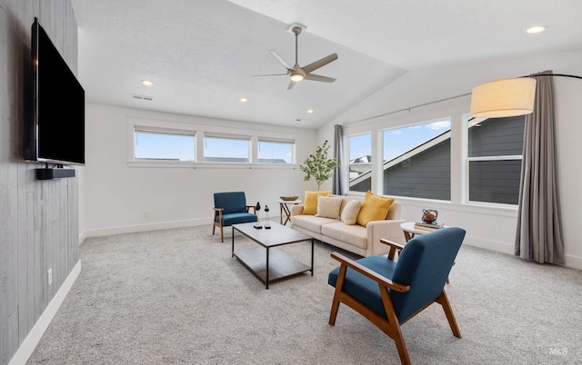 living area featuring lofted ceiling, baseboards, visible vents, and carpet floors