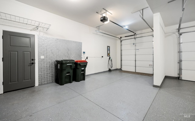 garage with a garage door opener and baseboards