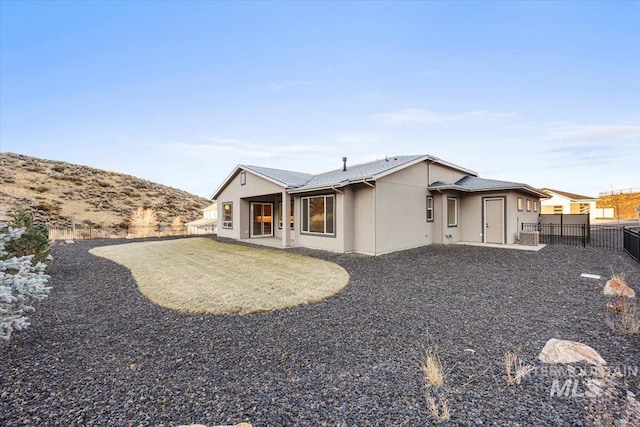 20042 N Swire Green Way Unit 459, Boise, ID 83714 - back of house with stucco siding and a fenced backyard