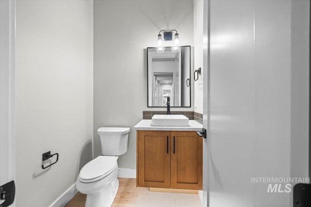 20042 N Swire Green Way Unit 459, Boise, ID 83714 - bathroom featuring toilet, vanity, wood finished floors, and baseboards