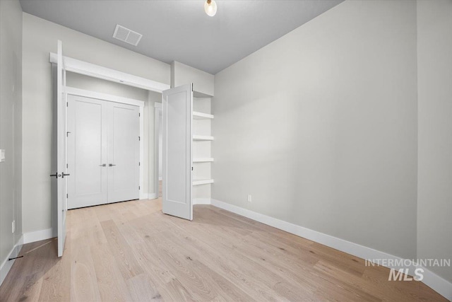 20042 N Swire Green Way Unit 459, Boise, ID 83714 - unfurnished bedroom with baseboards and light wood finished floors