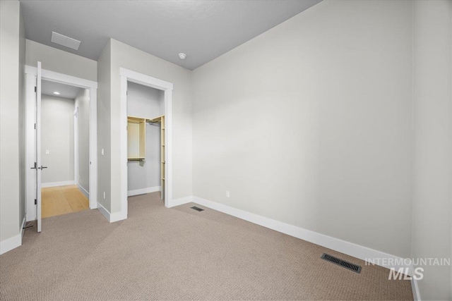 20042 N Swire Green Way Unit 459, Boise, ID 83714 - unfurnished bedroom with carpet, baseboards, a walk in closet, and a closet
