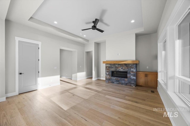 20042 N Swire Green Way Unit 459, Boise, ID 83714 - unfurnished living room featuring a tray ceiling, light wood-style flooring, ceiling fan, and recessed lighting
