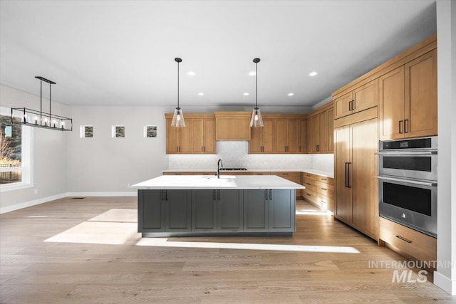 20042 N Swire Green Way Unit 459, Boise, ID 83714 - kitchen with stainless steel double oven, light countertops, light wood-style flooring, paneled built in refrigerator, and recessed lighting