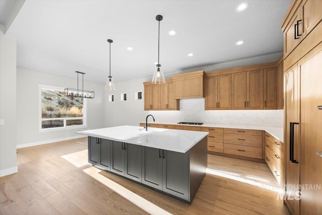20042 N Swire Green Way Unit 459, Boise, ID 83714 - kitchen with stovetop, baseboards, recessed lighting, light wood-type flooring, and an island with sink