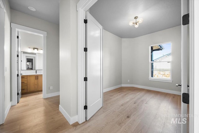 20042 N Swire Green Way Unit 459, Boise, ID 83714 - unfurnished bedroom featuring light wood-style flooring, baseboards, and ensuite bath
