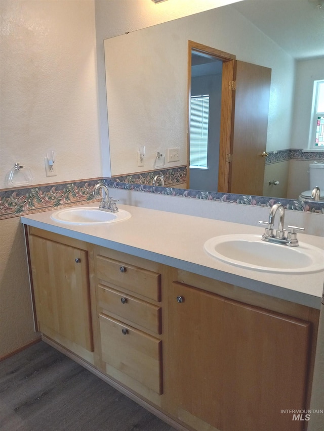 410 Cedar St, Middleton, ID 83644 - full bathroom featuring double vanity, wood finished floors, and toilet