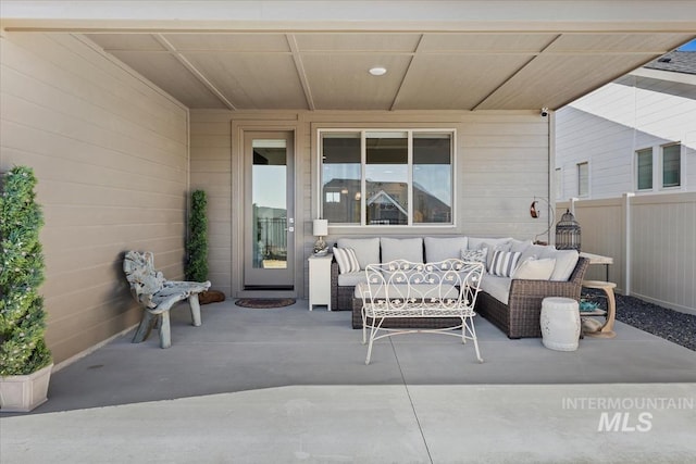 view of patio featuring an outdoor living space and fence