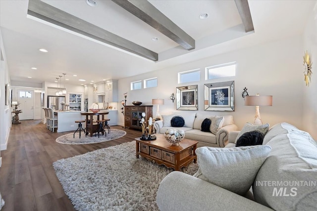 living room with dark wood finished floors, beamed ceiling, plenty of natural light, and recessed lighting