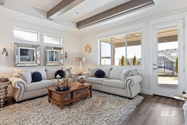 living area with beam ceiling and wood finished floors