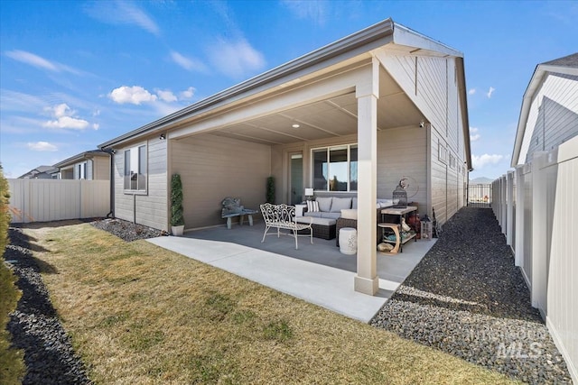 rear view of house with a patio, a yard, a fenced backyard, and an outdoor hangout area