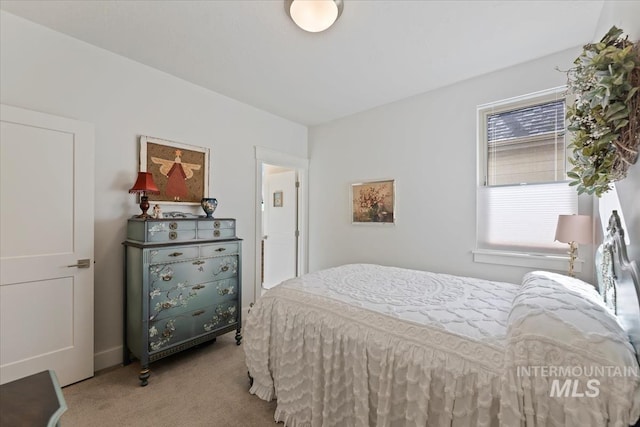 bedroom with multiple windows and carpet