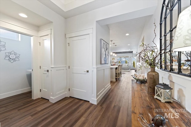 foyer entrance featuring recessed lighting, dark wood-type flooring, and baseboards