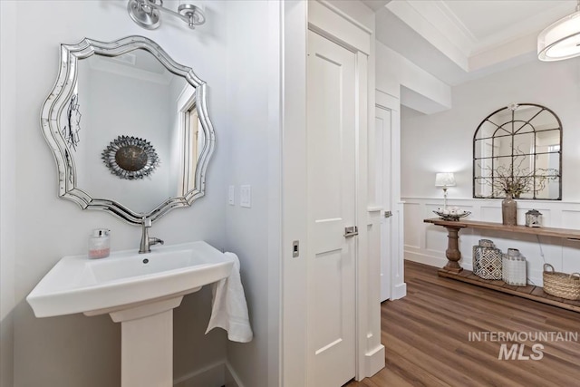 bathroom featuring crown molding and wood finished floors