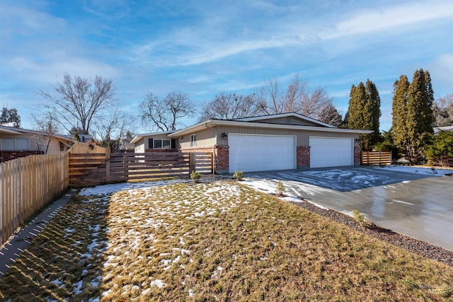 8561 W Goddard, Boise, ID 83704 - view of home's exterior with driveway, an attached garage, brick siding, and fence private yard