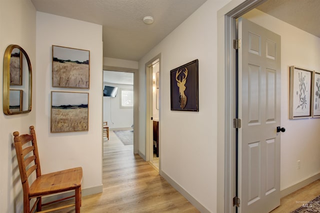 8561 W Goddard, Boise, ID 83704 - hallway featuring baseboards and light wood finished floors