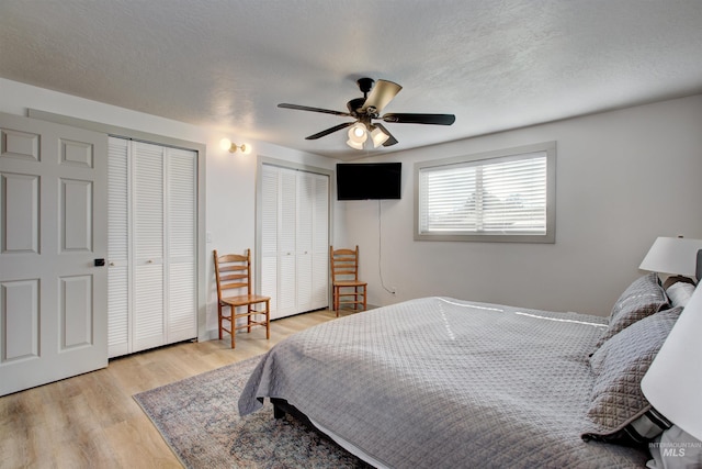 8561 W Goddard, Boise, ID 83704 - bedroom featuring a ceiling fan, light wood finished floors, multiple closets, and a textured ceiling