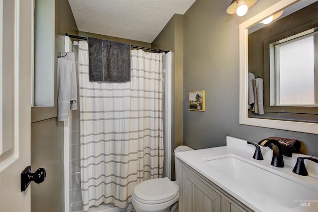 8561 W Goddard, Boise, ID 83704 - full bath with toilet, vanity, and a textured ceiling