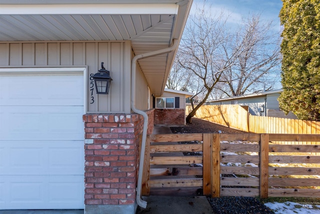 8561 W Goddard, Boise, ID 83704 - exterior space featuring an attached garage, fence, and board and batten siding