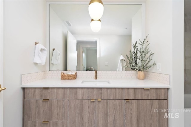 4184 E Haystack St Unit 206, Boise, ID 83716 - bathroom with vanity and tasteful backsplash