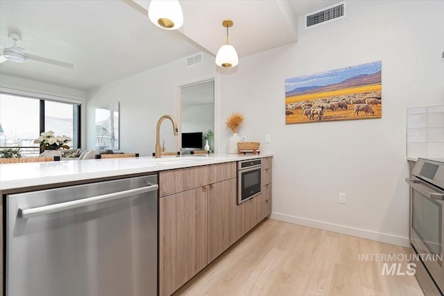 4184 E Haystack St Unit 206, Boise, ID 83716 - kitchen with stainless steel appliances, light wood-type flooring, light countertops, modern cabinets, and decorative light fixtures