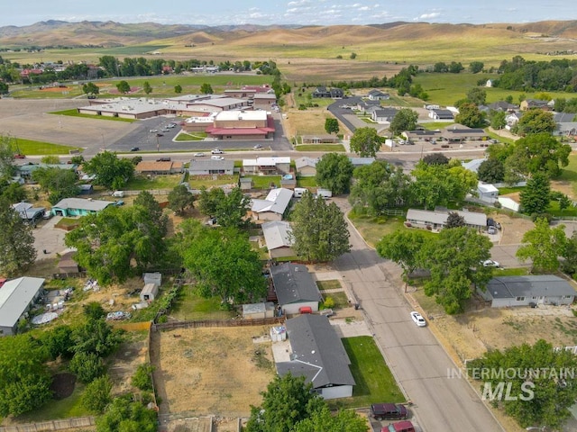 1765 W 6th St, Weiser, ID 83672 - aerial view of property and surrounding area featuring mountains and nearby suburban area