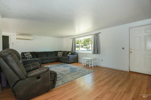 1765 W 6th St, Weiser, ID 83672 - living area featuring a wall unit AC, wood finished floors, and a textured ceiling