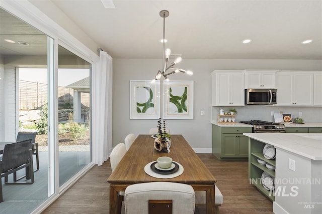5591 W Aralia Dr, Meridian, ID 83646 - dining area featuring recessed lighting, dark wood-style floors, baseboards, and an inviting chandelier