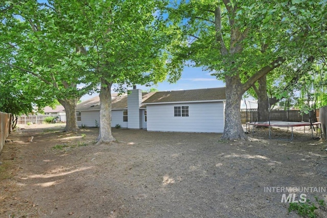 3118 Fircrest Ave, Caldwell, ID 83605 - rear view of property featuring a trampoline and a fenced backyard