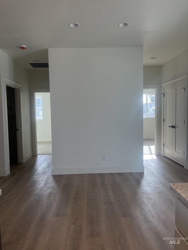 spare room featuring visible vents, baseboards, wood finished floors, and recessed lighting