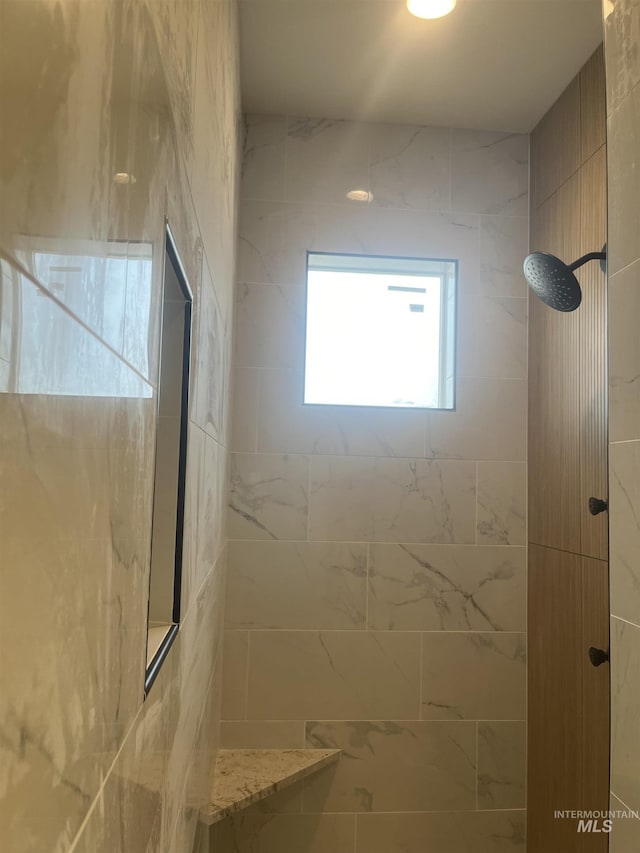 bathroom with a tile shower