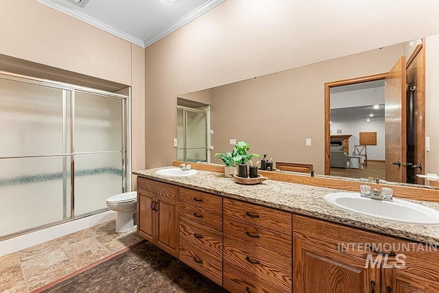 9817 W Gurdon Ct, Boise, ID 83704 - bathroom featuring double vanity, a stall shower, crown molding, and stone finish floors