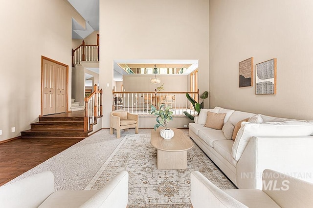 9817 W Gurdon Ct, Boise, ID 83704 - living area with a high ceiling, stairs, a chandelier, and wood finished floors