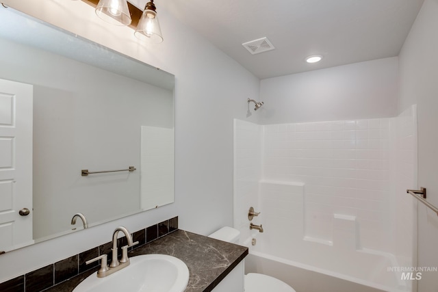 full bathroom featuring toilet, recessed lighting, vanity, visible vents, and tub / shower combination