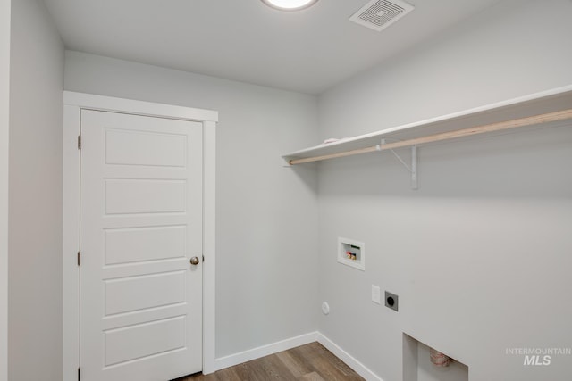 laundry area with hookup for a washing machine, hookup for an electric dryer, laundry area, dark wood-type flooring, and visible vents