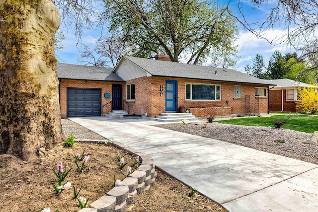 1706 Hervey, Boise, ID 83705 - ranch-style home with concrete driveway, an attached garage, a chimney, and brick siding