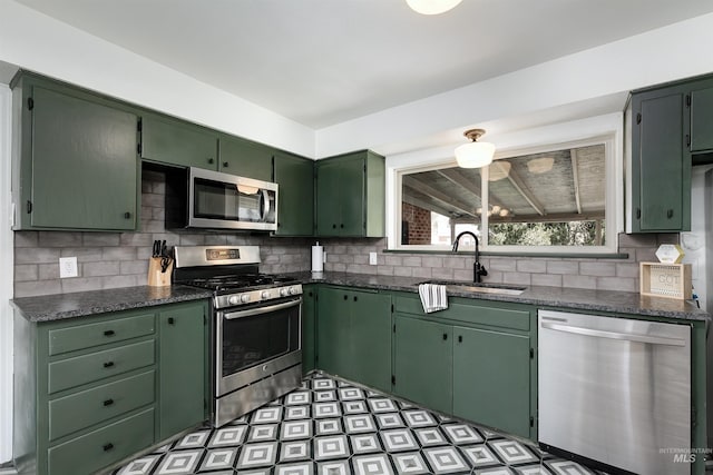 1706 Hervey, Boise, ID 83705 - kitchen featuring a sink, light floors, backsplash, green cabinets, and appliances with stainless steel finishes