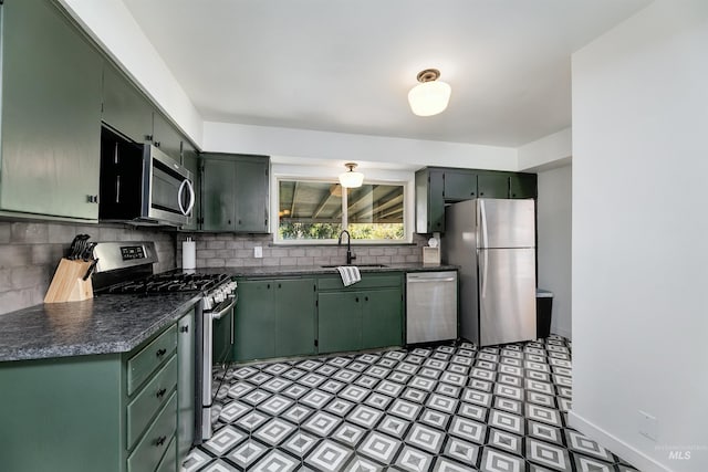 1706 Hervey, Boise, ID 83705 - kitchen featuring green cabinets, dark countertops, appliances with stainless steel finishes, and a sink