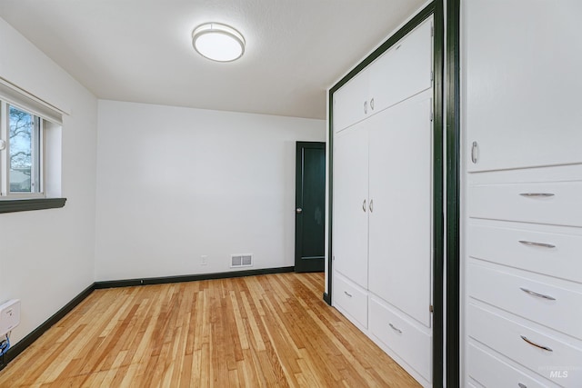 1706 Hervey, Boise, ID 83705 - unfurnished bedroom featuring light wood finished floors, visible vents, and baseboards