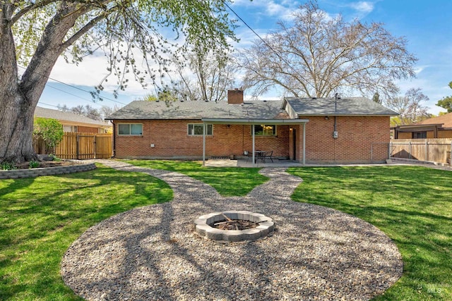 1706 Hervey, Boise, ID 83705 - rear view of house with an outdoor fire pit, a patio area, brick siding, and fence