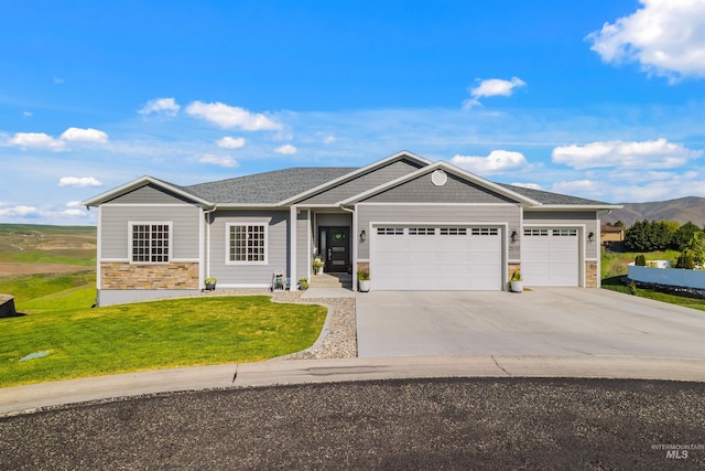 2510 Westridge Ct, Clarkston, WA 99403 - view of front of home with a mountain view, stone siding, driveway, a garage, and a front lawn