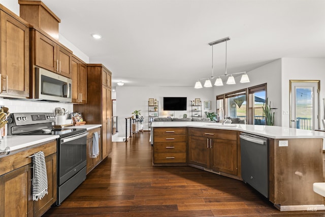 2510 Westridge Ct, Clarkston, WA 99403 - kitchen with a sink, dark wood finished floors, open floor plan, light countertops, and appliances with stainless steel finishes