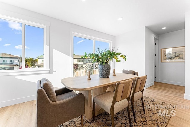 dining room featuring light wood-style floors, baseboards, and recessed lighting