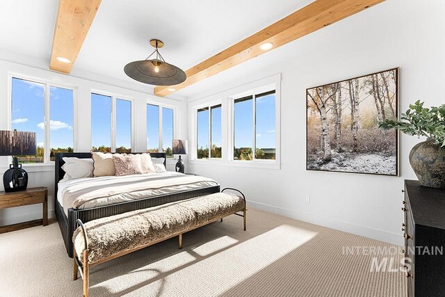 carpeted bedroom with beam ceiling and baseboards