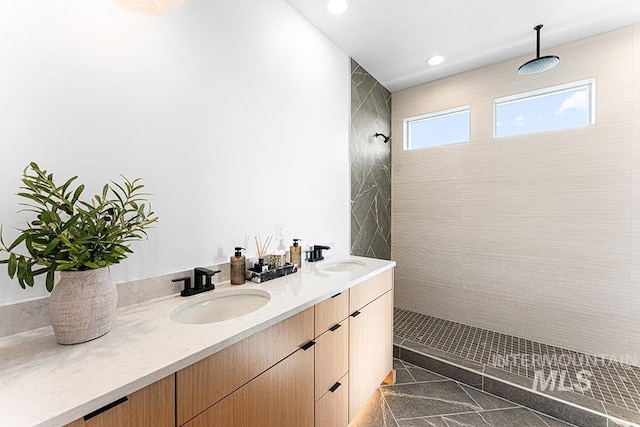 full bath with a walk in shower, recessed lighting, and double vanity
