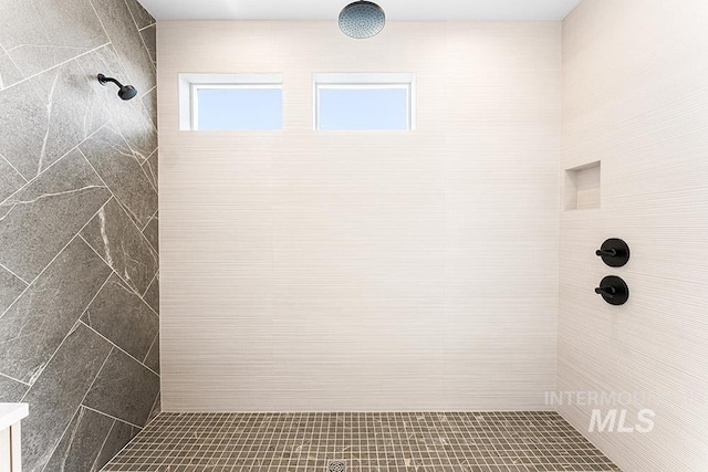 bathroom with tiled shower