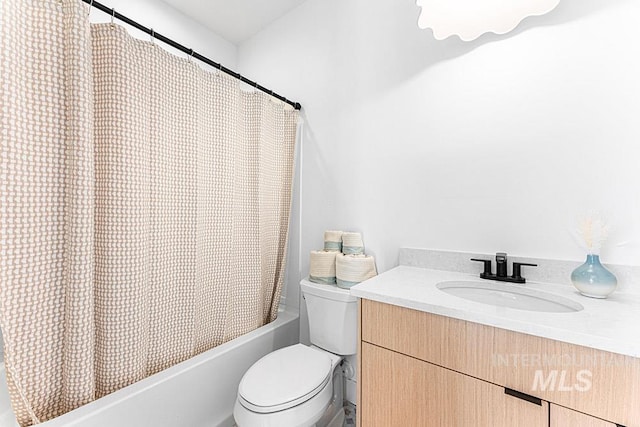 bathroom with toilet, shower / bath combination with curtain, and vanity